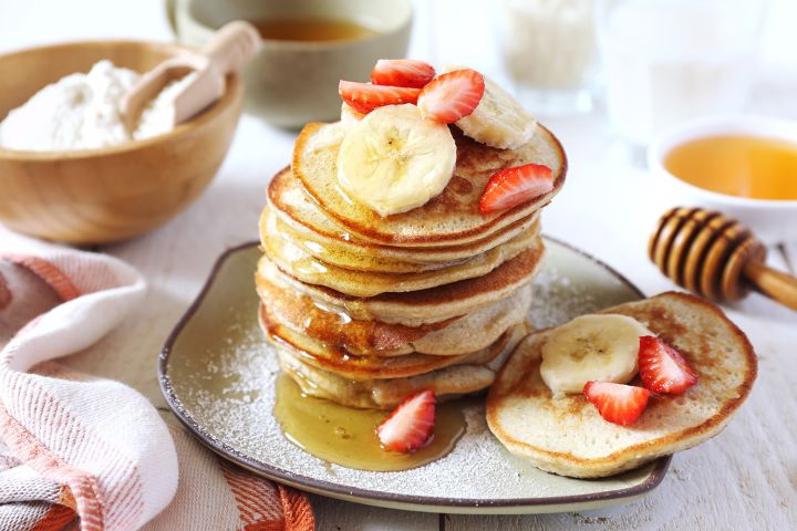 3 Ingredient Banana and Egg Pancakes Banana and egg pancakes with maple syrup and sliced bananas.
