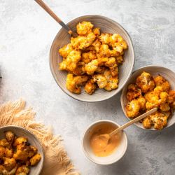 Bang Bang Cauliflower Bang bang cauliflower baked with breadcrumbs and tossed in a sweet and spicy orange sauce.