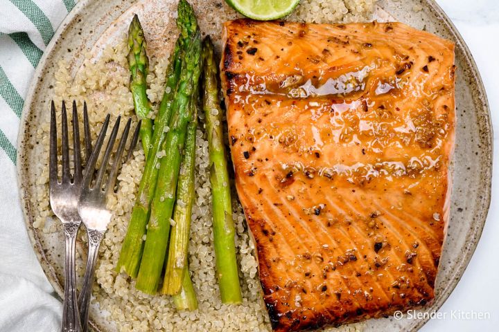 Easy Honey Garlic Broiled Salmon Broiled salmon with honey garlic sauce on a plate with asparagus.