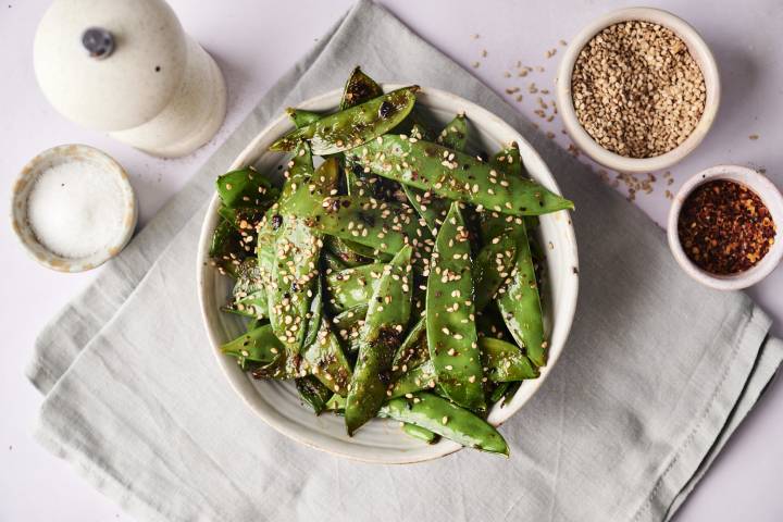 Sesame Sugar Snap Peas A finished bowl of sesame sugar snap peas, garnished with sesame seeds.