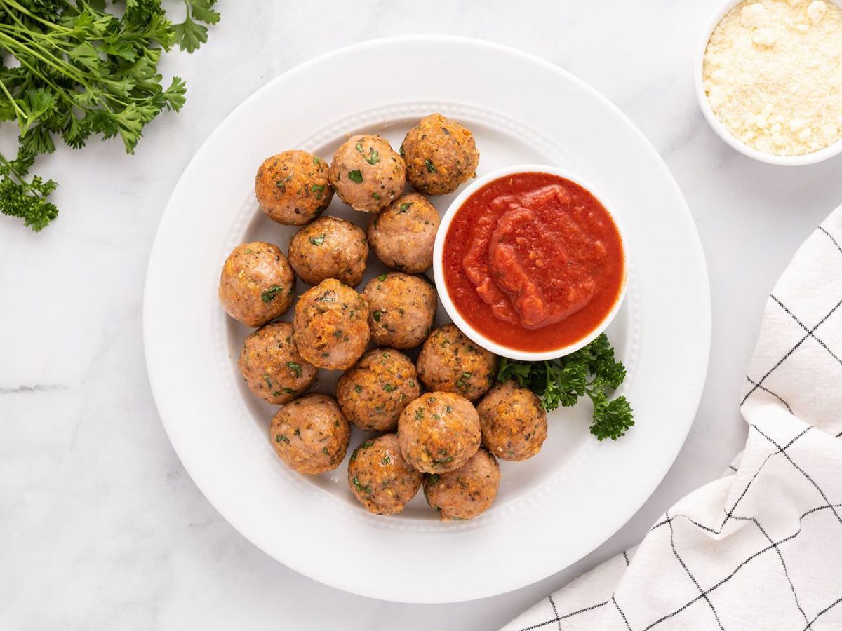 Healthy Freezer Friendly Recipes Turkey Meatballs on a white plate accompanied with sauce